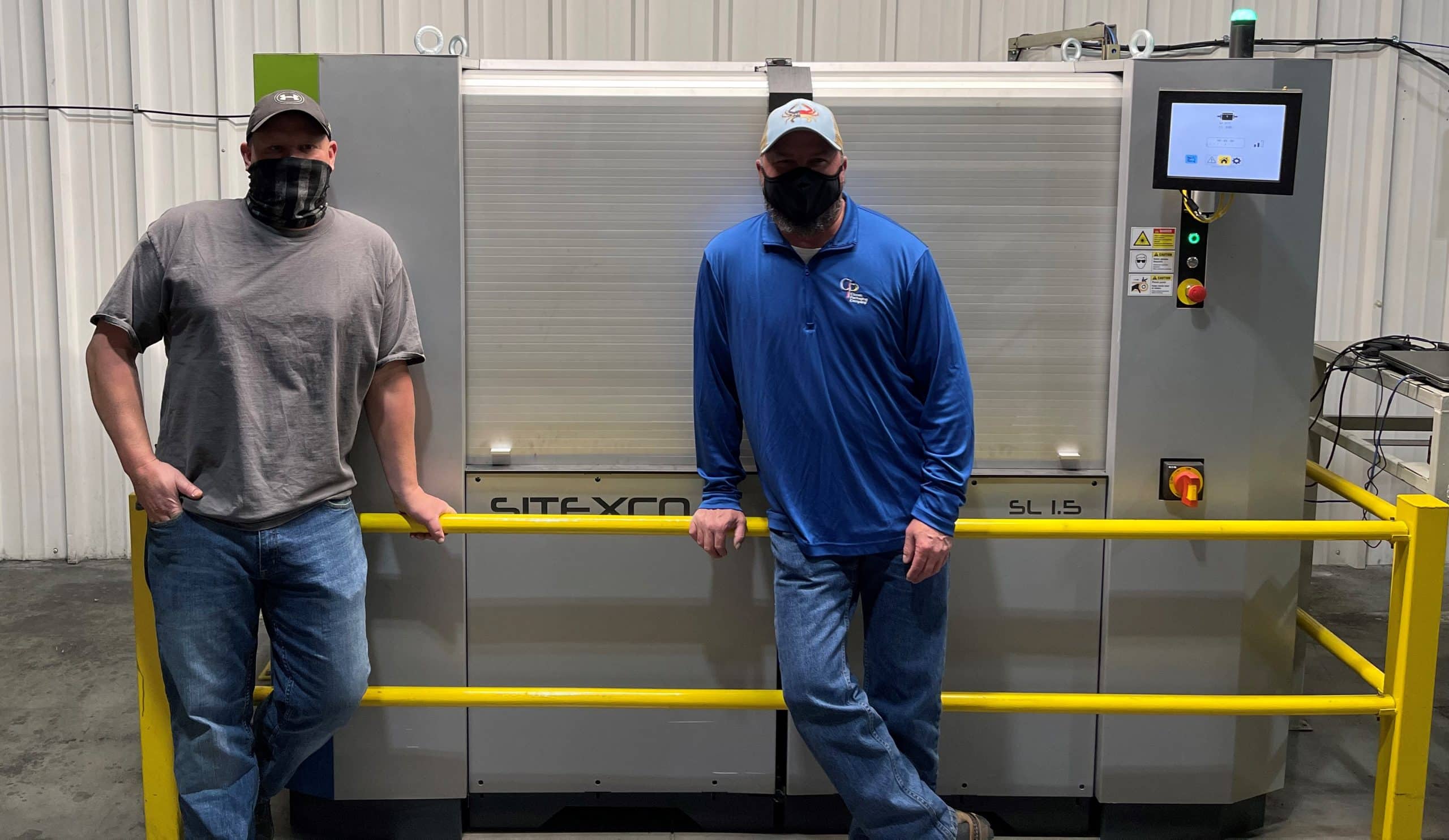 Two Classic Packaging employees together on the production floor.