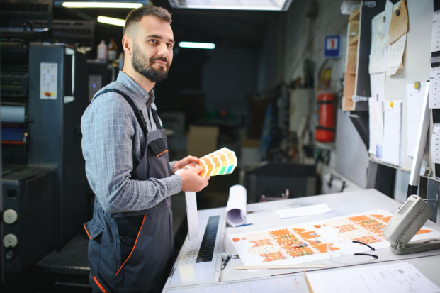 Worker in prepress stage designing for flexographic label printing.