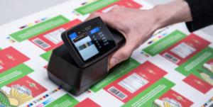 Handheld X-Rite eXact 2 spectrophotometer with touchscreen display, used for precise color measurement in printing and packaging industries.