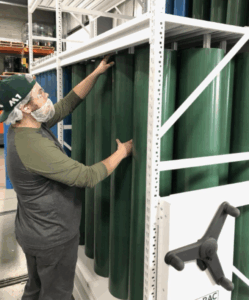 A worker organizing and retrieving flexographic printing sleeves from a Flexopodz mobile storage unit