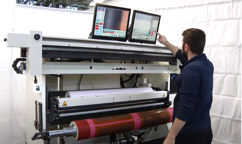 Operator overseeing flexographic support equipment.